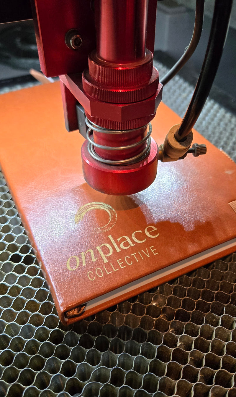 Leather notebook being laser engraved at Gnarly Mangrove Designs in Bradenton, Florida.