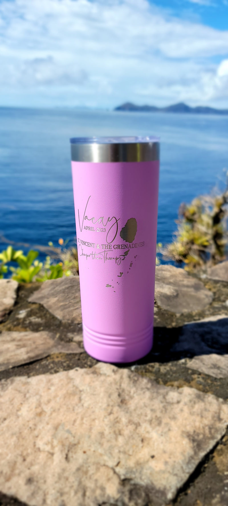 pink Laser Engraved tumbler with an ocean view in the background